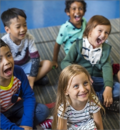 Kids sitting on flooring laughing